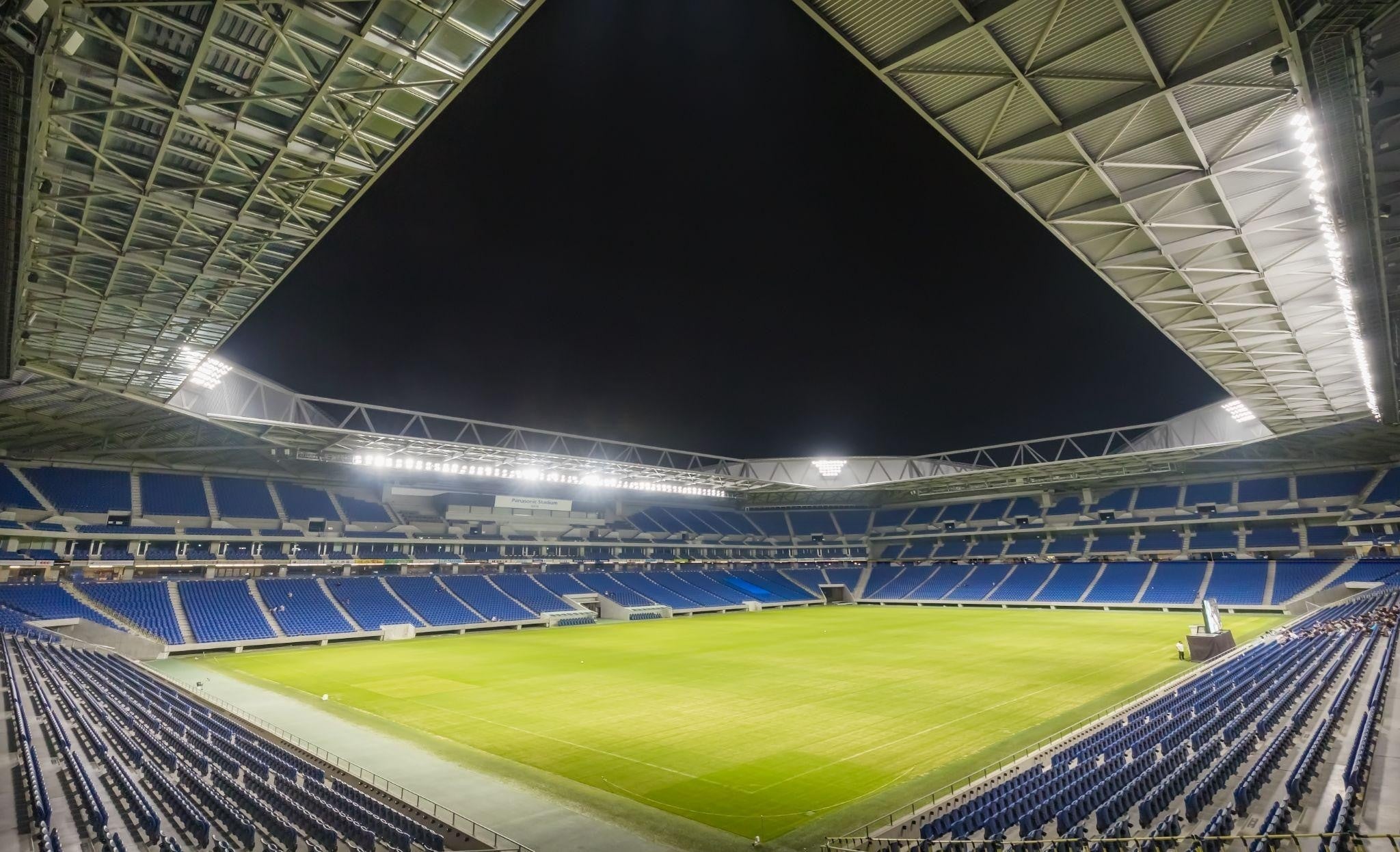Night view of a football stadium under lights, illustrating stadium power outage planning and an event-day power outage response plan.