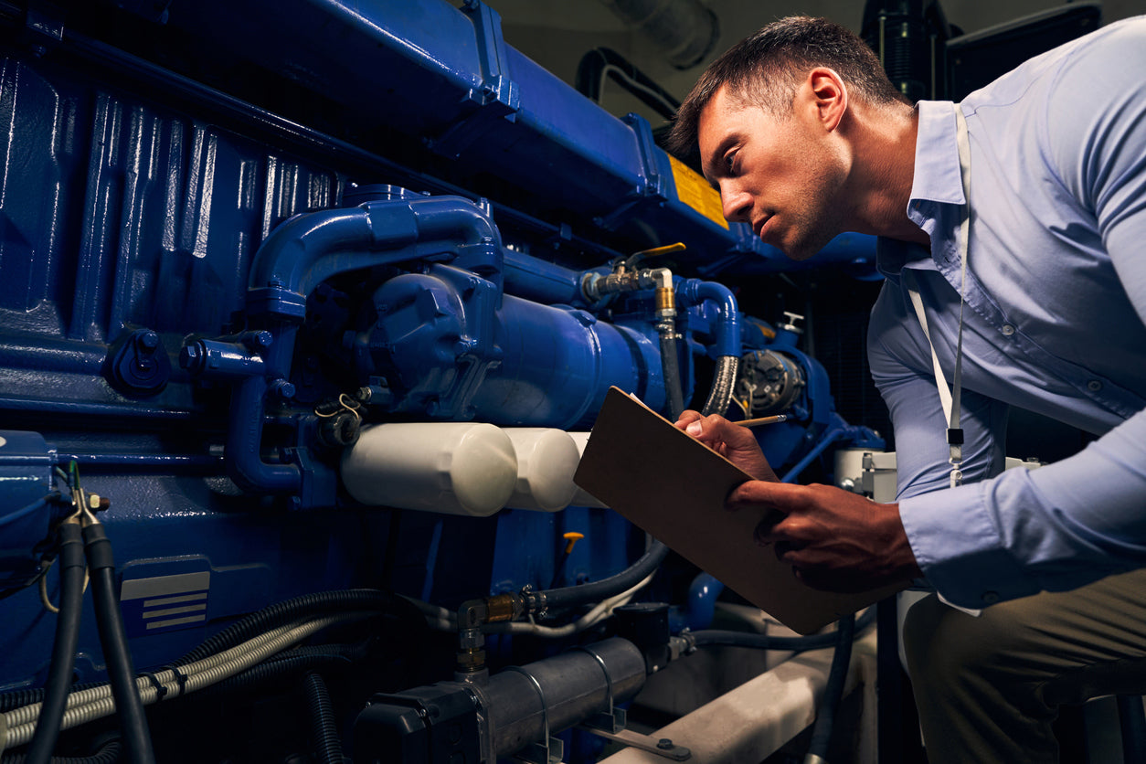 A technician inspects a generator before performing a load bank test. 
